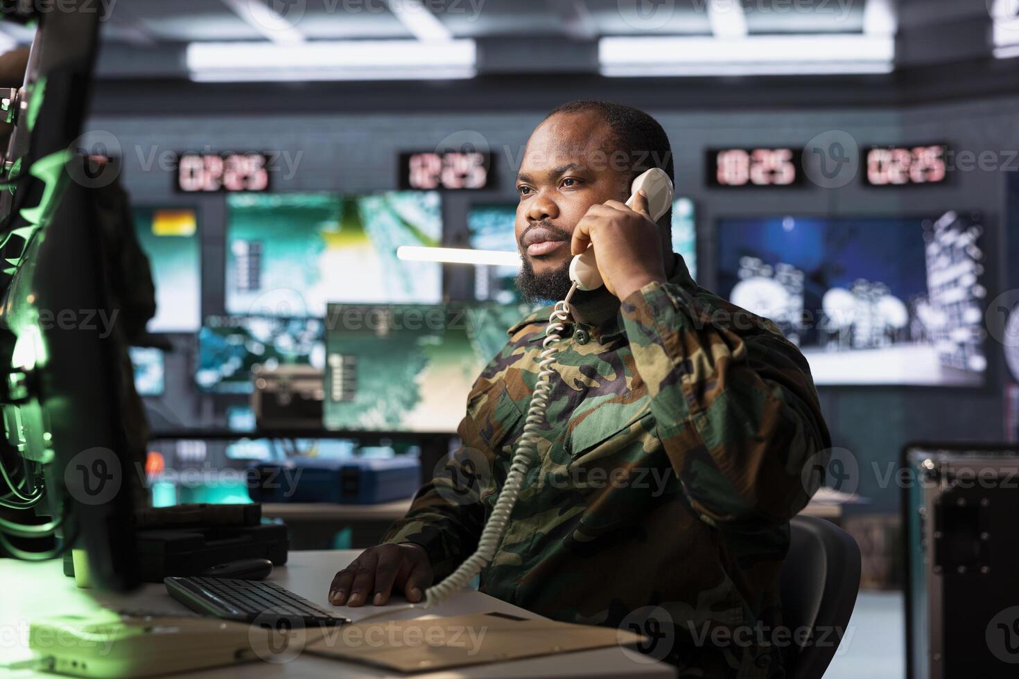 Military officer using a telephone in control room photo