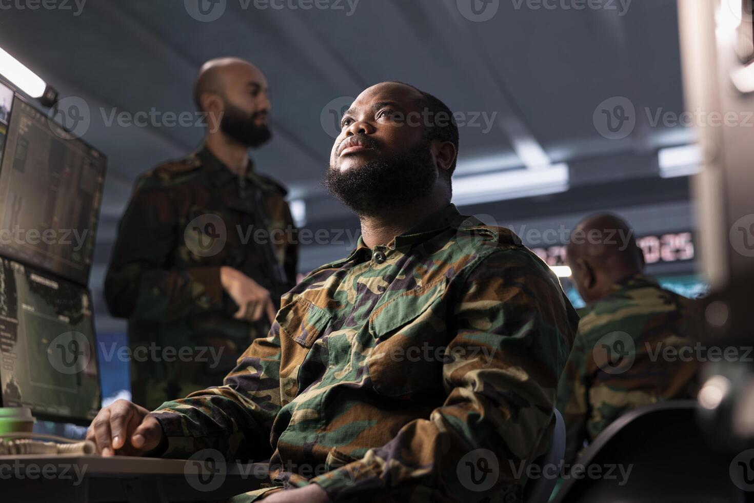 Air defense command specialist using radar equipment to detect incoming ballistic missiles. African american army soldier in base of operations scanning rockets approaching borders, deploying shields photo