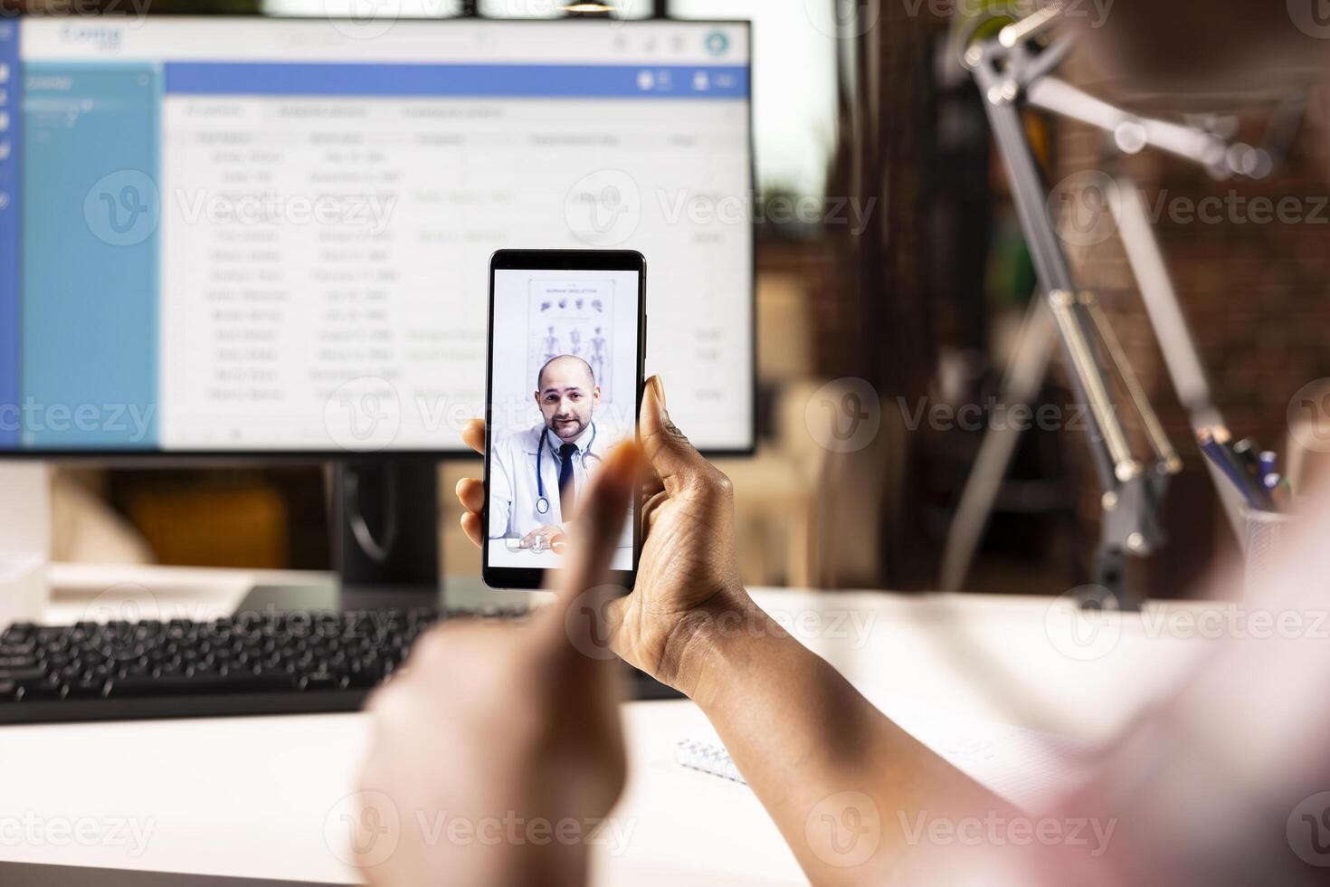Selective focus on white male physician offering online consultation during call with african american patient. Caucasian doctor on virtual meeting assisting black individual remotely. photo