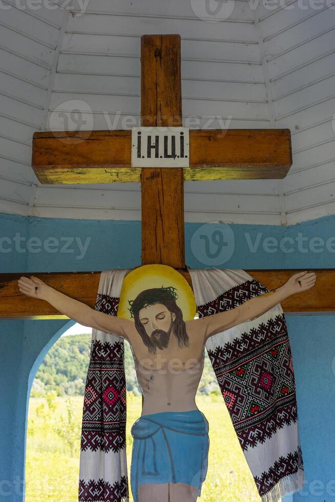 Chapel in Teresva, Transcarpathia features a crucifix surrounded by serene landscapes photo