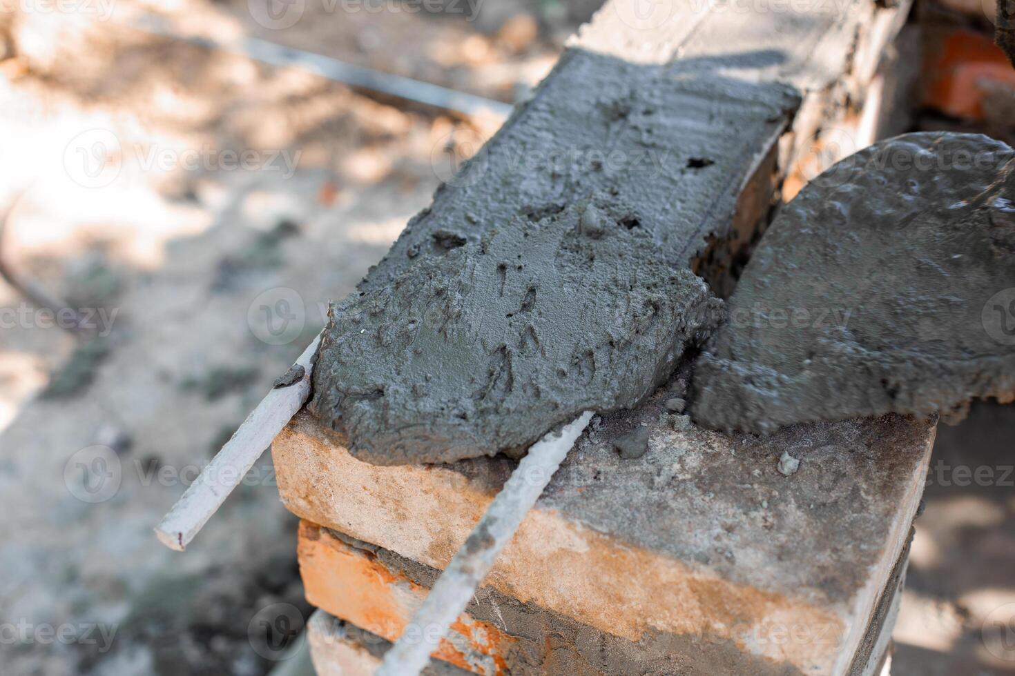 application wet cement on brick structure showing texture and process of barbecue construction. photo