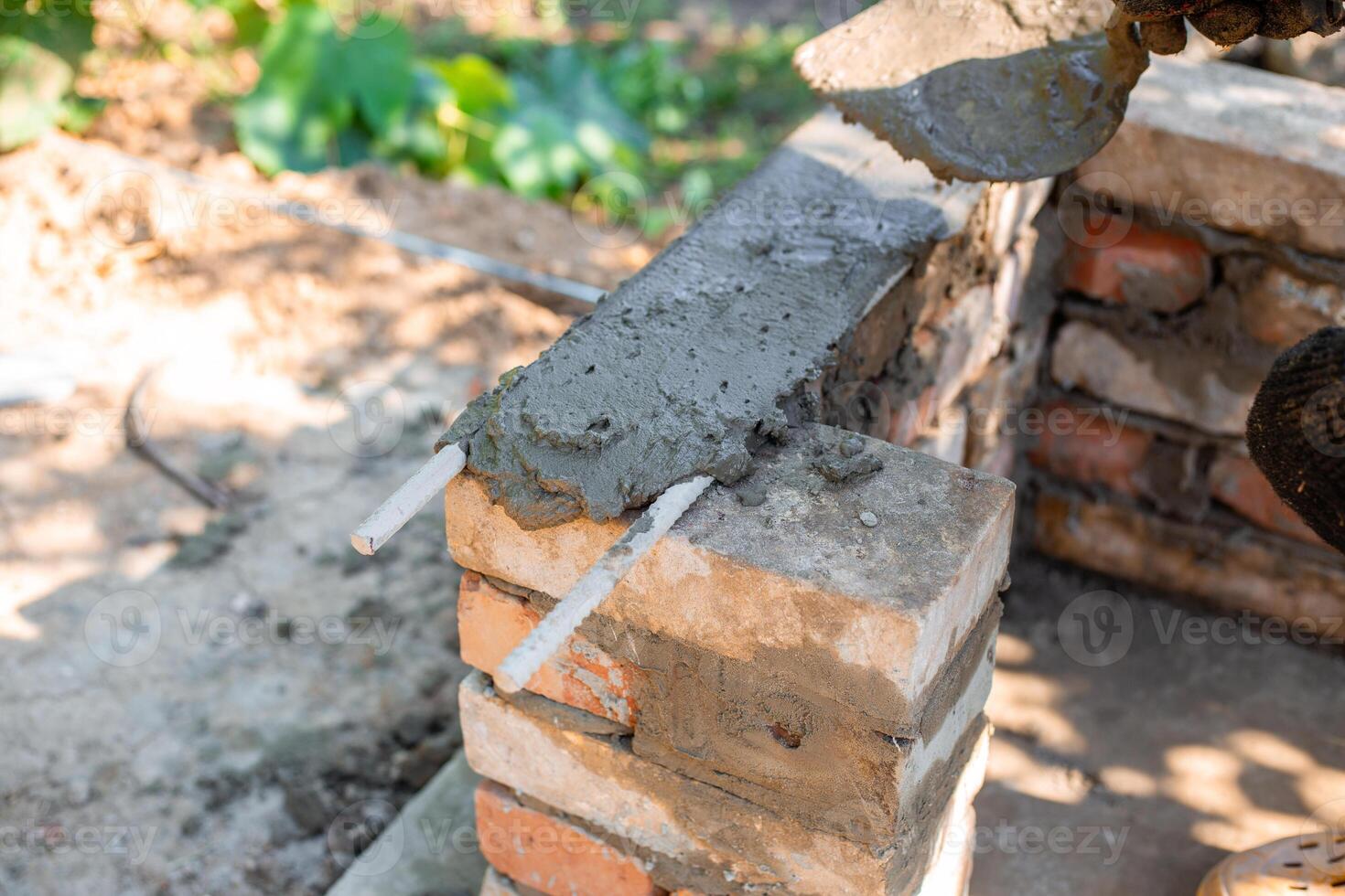 application of wet cement on brick structure showing texture and process barbecue construction, photo