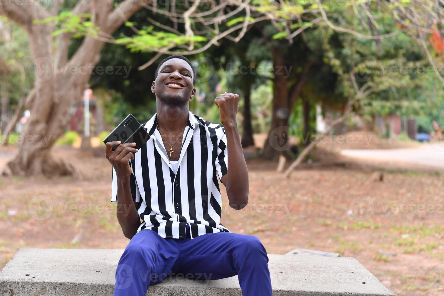 Handsome african man outdoors using smart phone photo