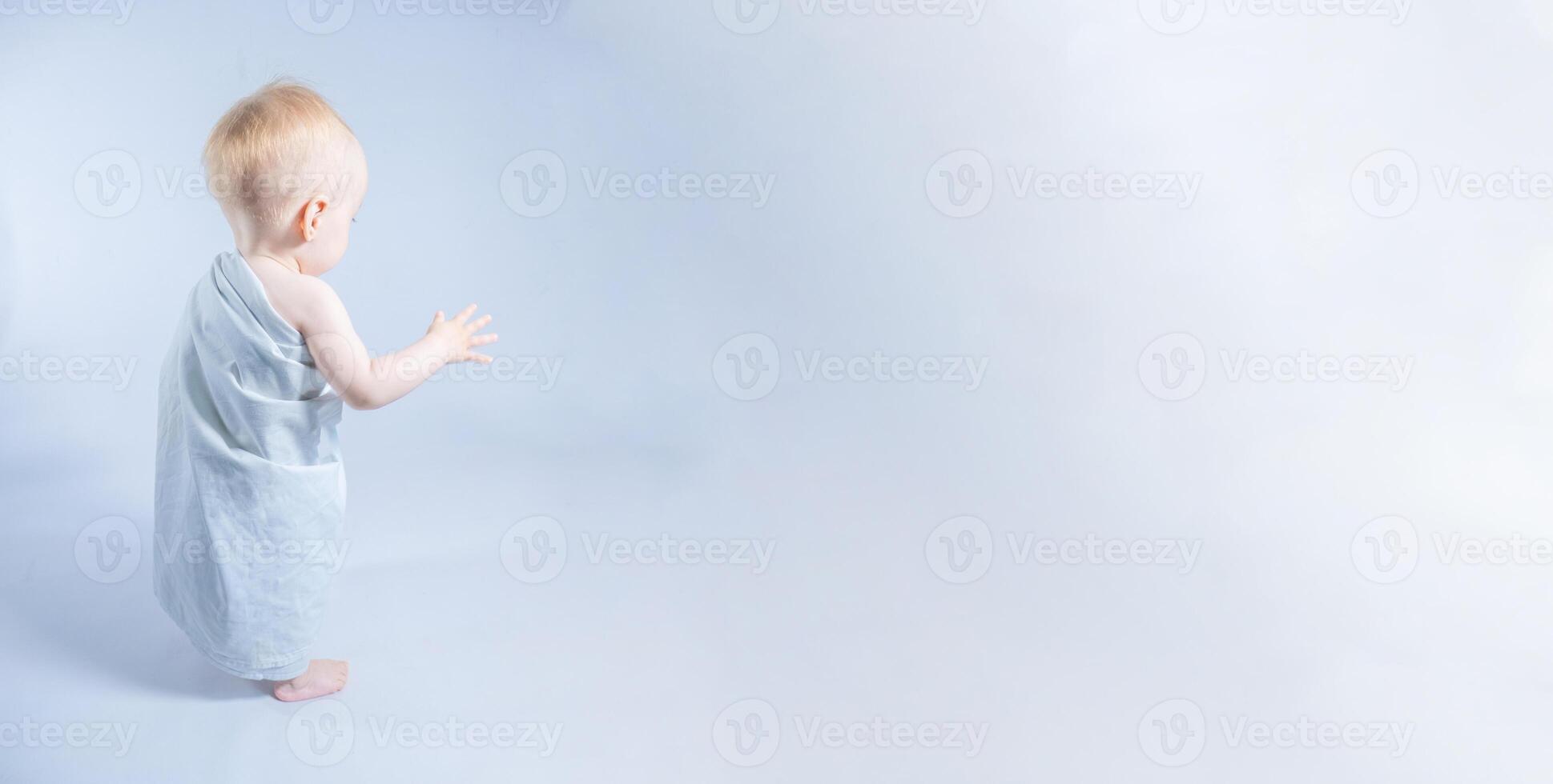A yearling in a toga points to a bright space. a banner with a place for the text photo