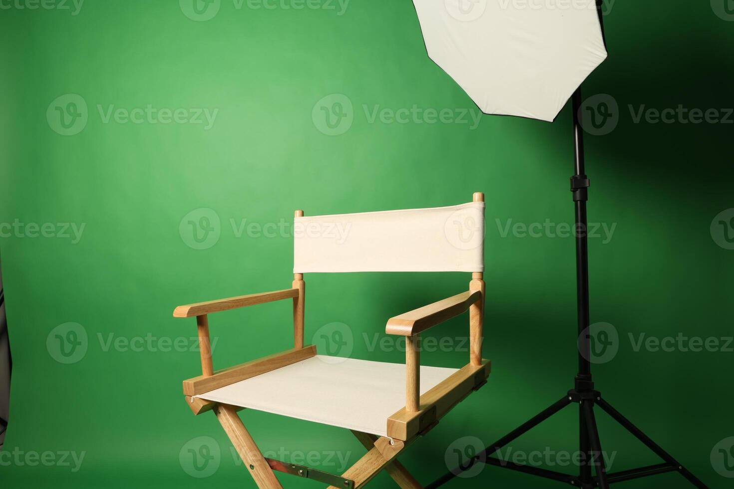 Chair of Film Director. Directors chair in green screen studio setup with softbox lighting. Ideal for filmmaking production photo interviews and creative content with green chroma key background