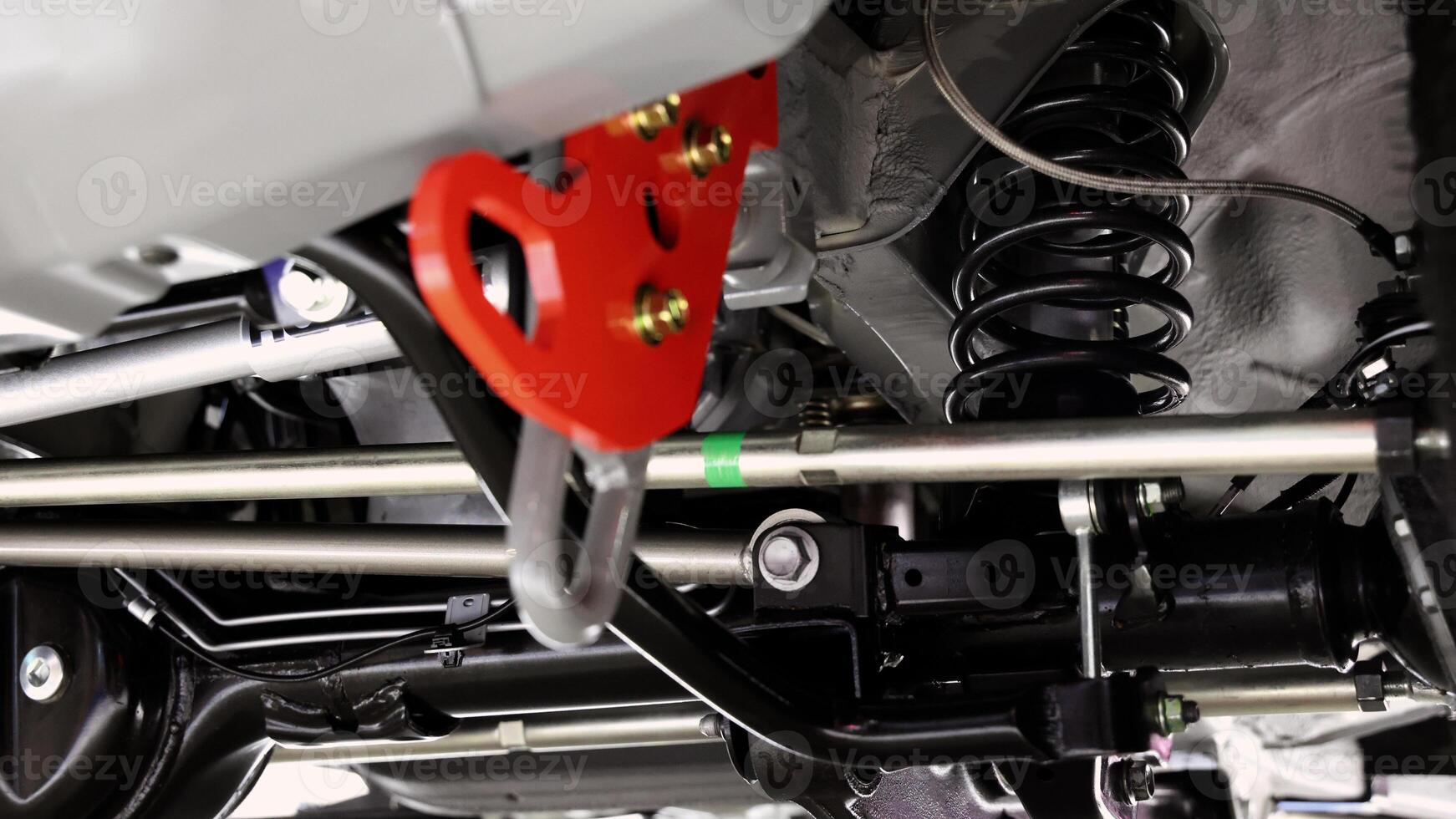 Car suspension parts. Close up of a rear car suspension and exhaust system. photo