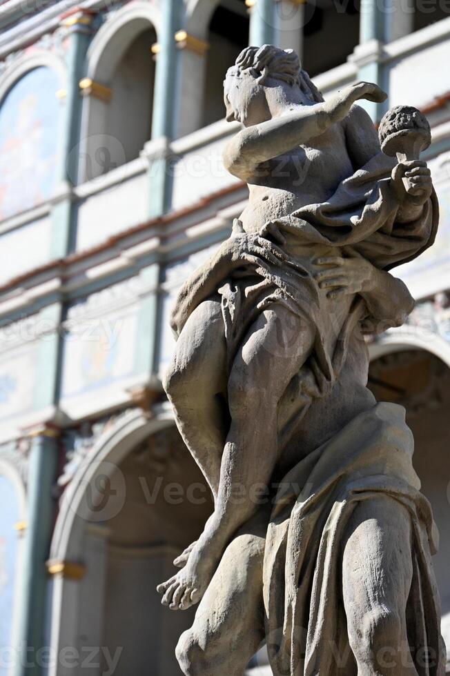 a statue of a man carrying a woman on his back photo