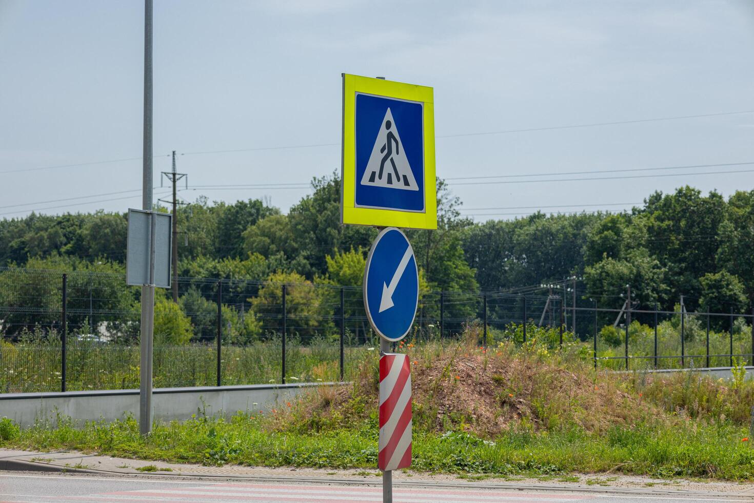 Road signs provide instructions for drivers, signaling upcoming construction and guiding traffic direction on a warm day photo