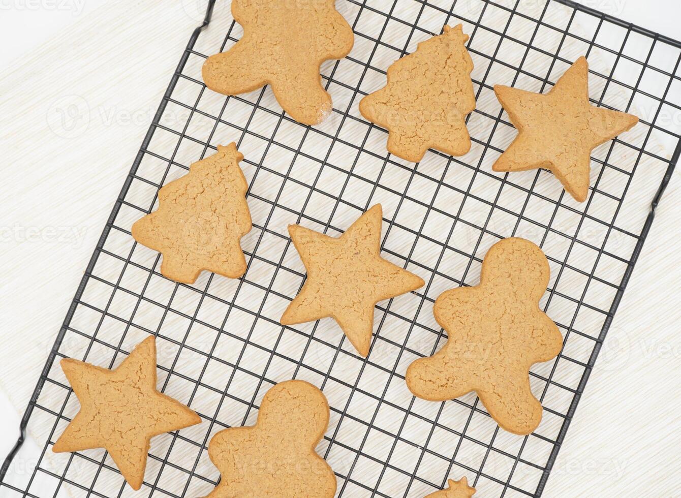 Freshly Baked Gingerbread Biscuits on Cooling Rack side view of Holiday Christmas Cookies photo
