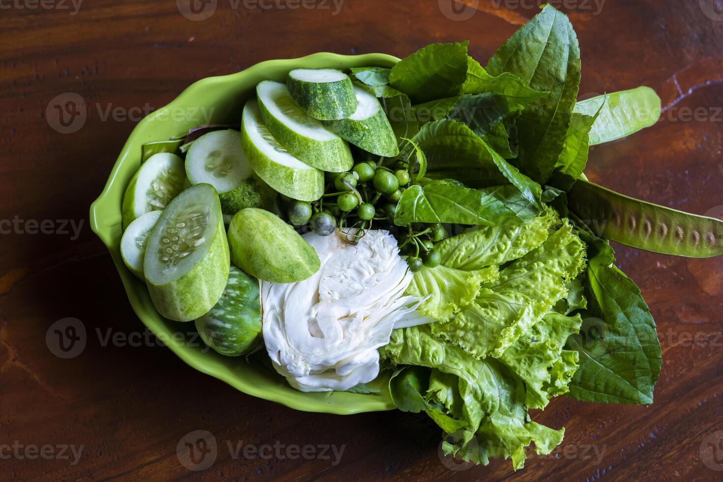 Lalapan or fresh raw vegetables basket. eaten with chili sauce as a complementary food authentic indonesian food photo