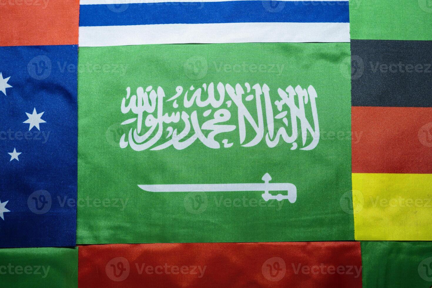 Saudi Flag Against a Multinational Flag Backdrop photo