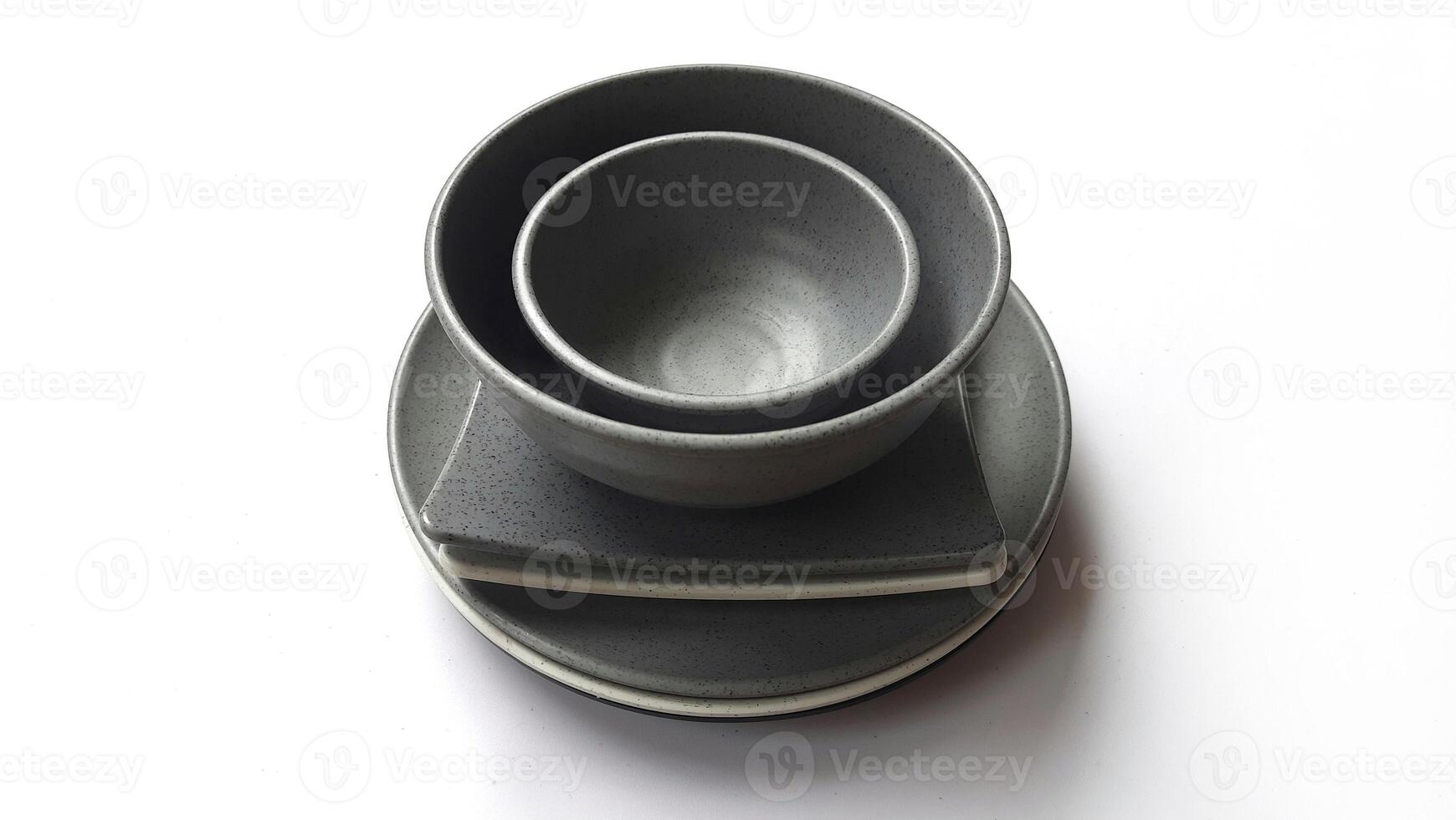 Stack of empty circle grey bowls and empty white grey square plates with ceramic melamin material isolated on white background. Clipping path photo