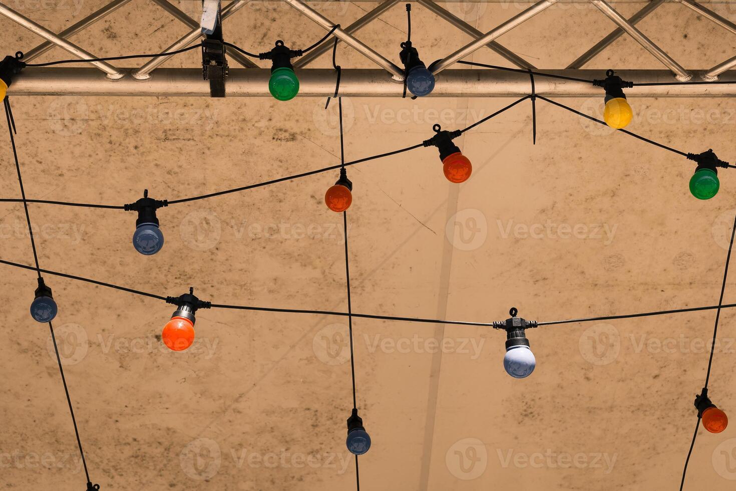 Colorful decorative lights create a festive atmosphere under a tent during an evening gathering in a warm summer setting photo