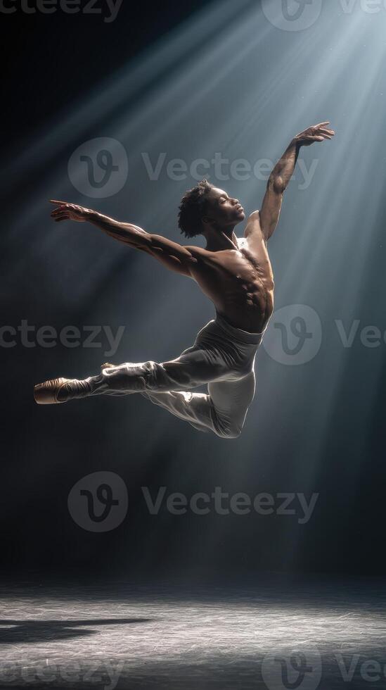 Ballet dancer athletic male leaping spotlight dramatic stage muscular grace photo