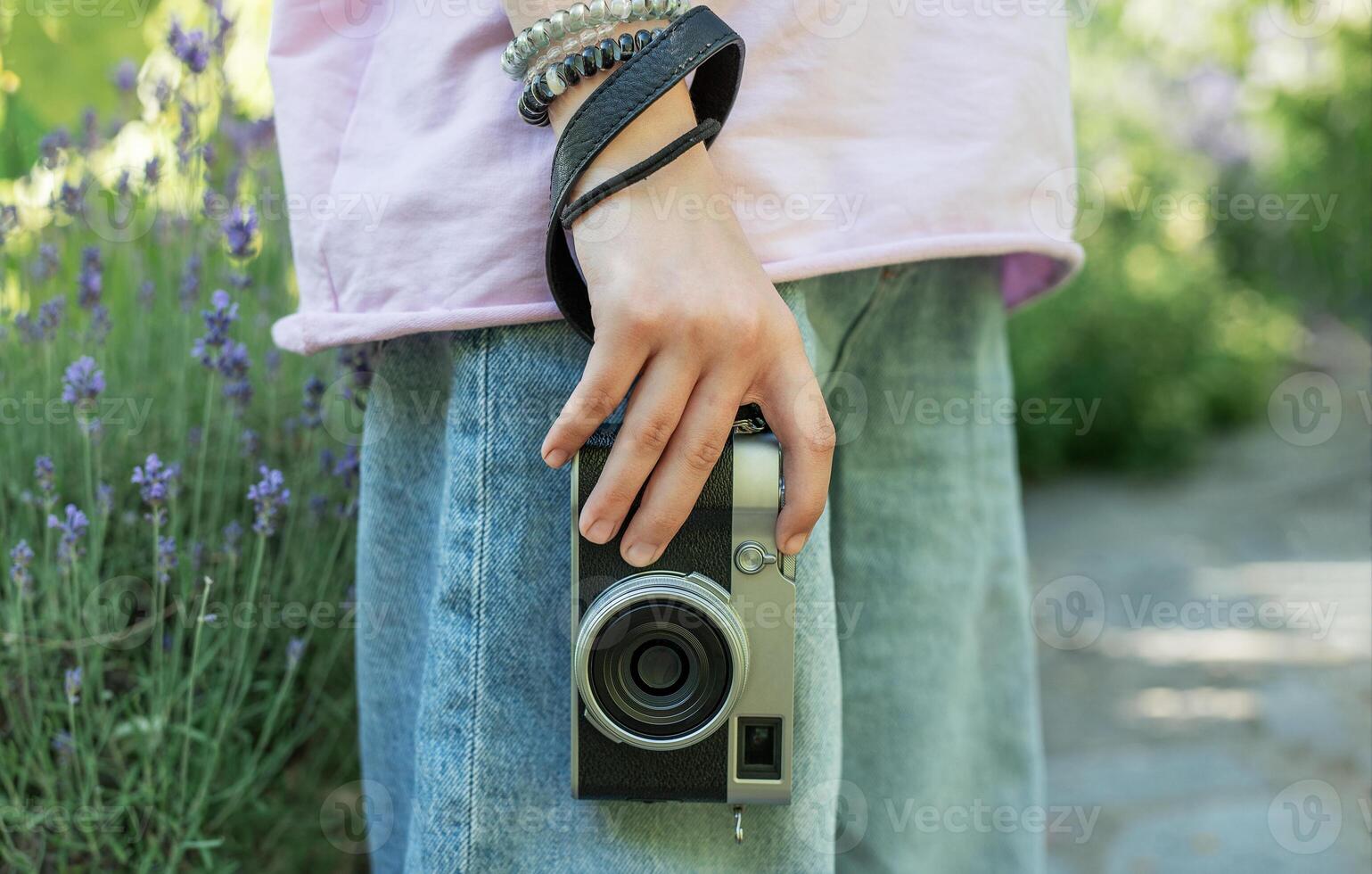 Photographer holding vintage camera in lavender field photo
