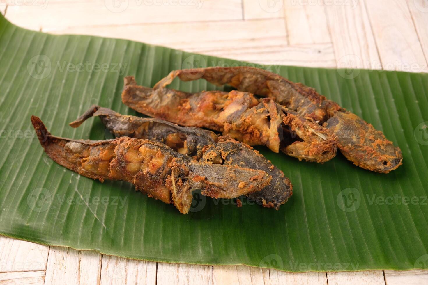 fried catfish on a banana leaf. Lele goreng. Pecel lele photo