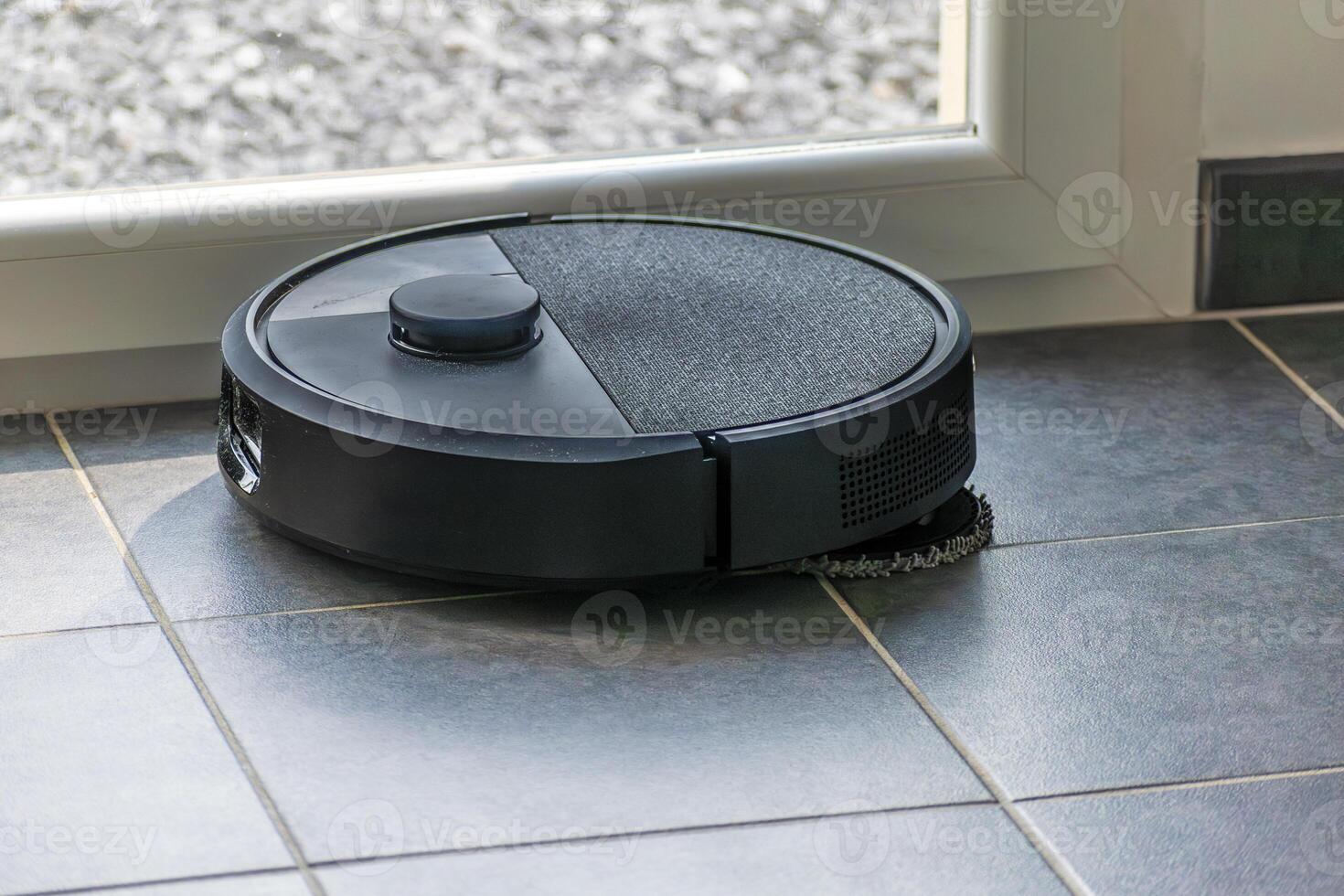 Robot vacuum cleaner with dust, real life photo, saves time and goes into hard-to-reach places, tech photo