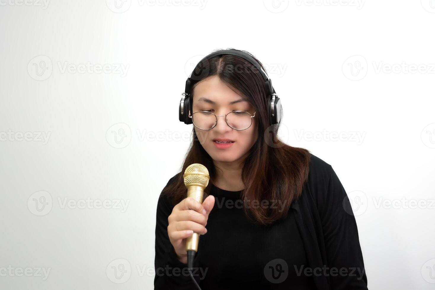 A woman wearing headphones and holding a microphone photo