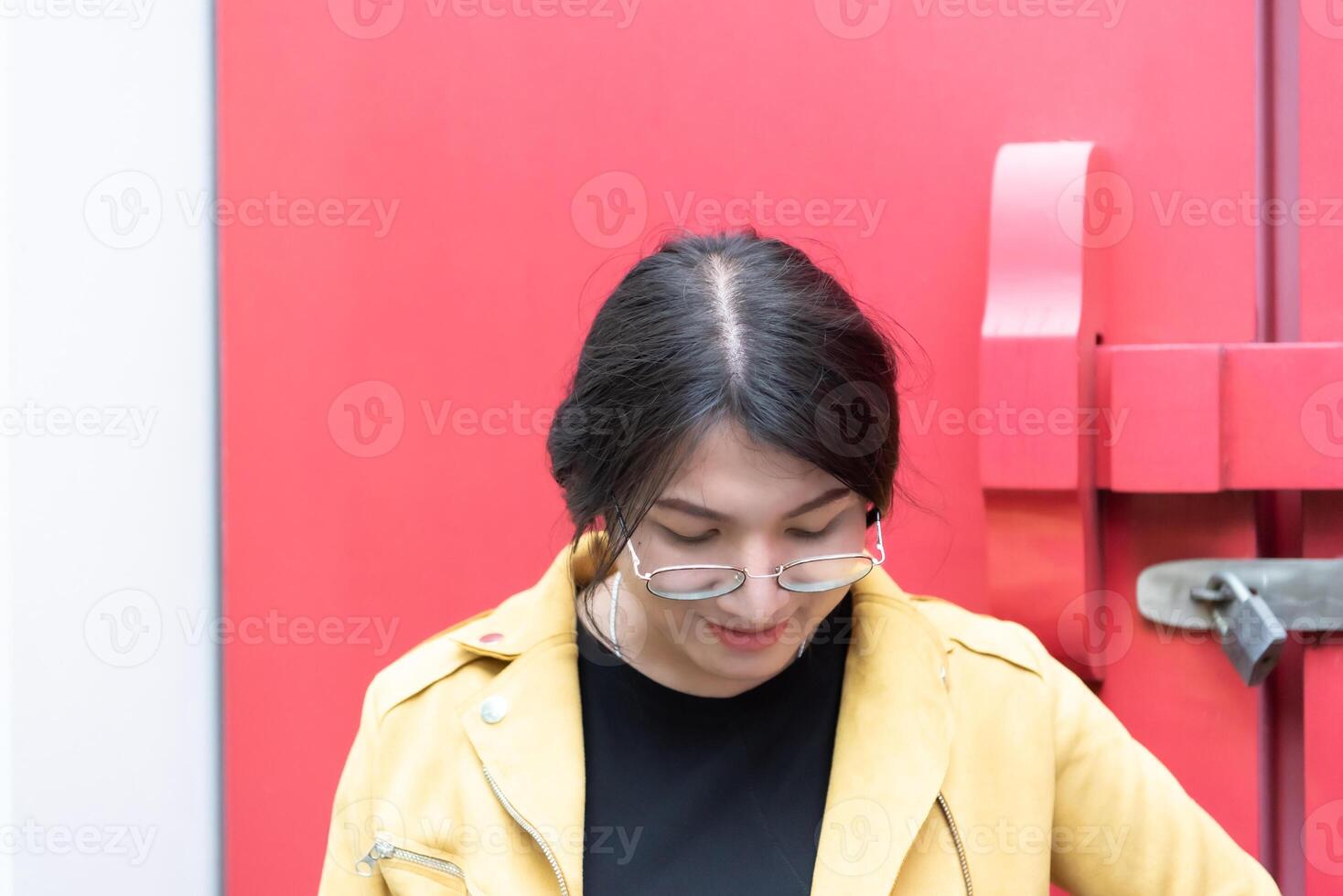 A woman in glasses and a yellow jacket photo