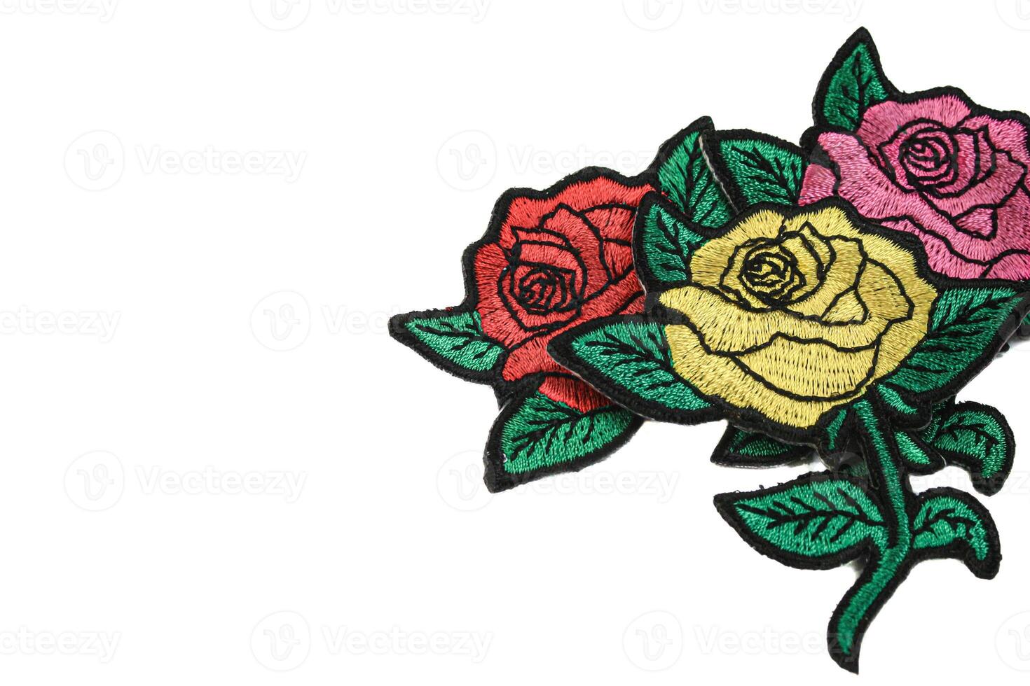 Horizontal embroidery of three roses in yellow, pink, and red, placed on the right side against a clean white background with text space on the left. Perfect romantic design for weddings and love. photo