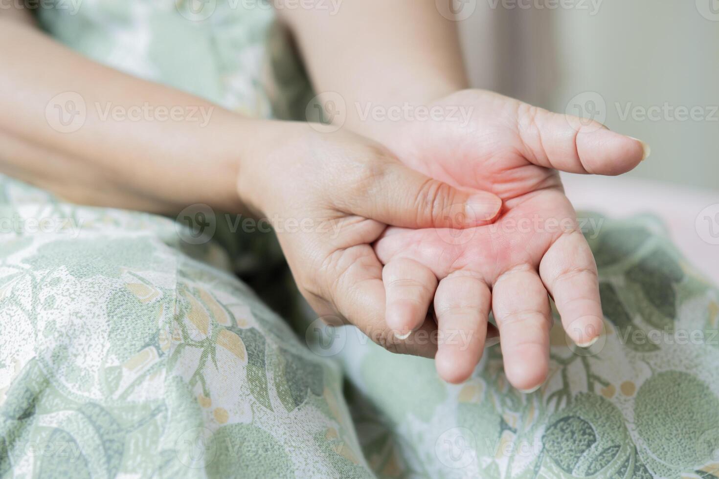 Asian senior or elderly old woman patient pain finger and hand while sitting on bed in bedroom. photo