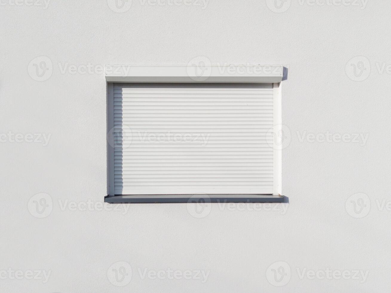 Closed White Window Shutter on Minimal Wall photo