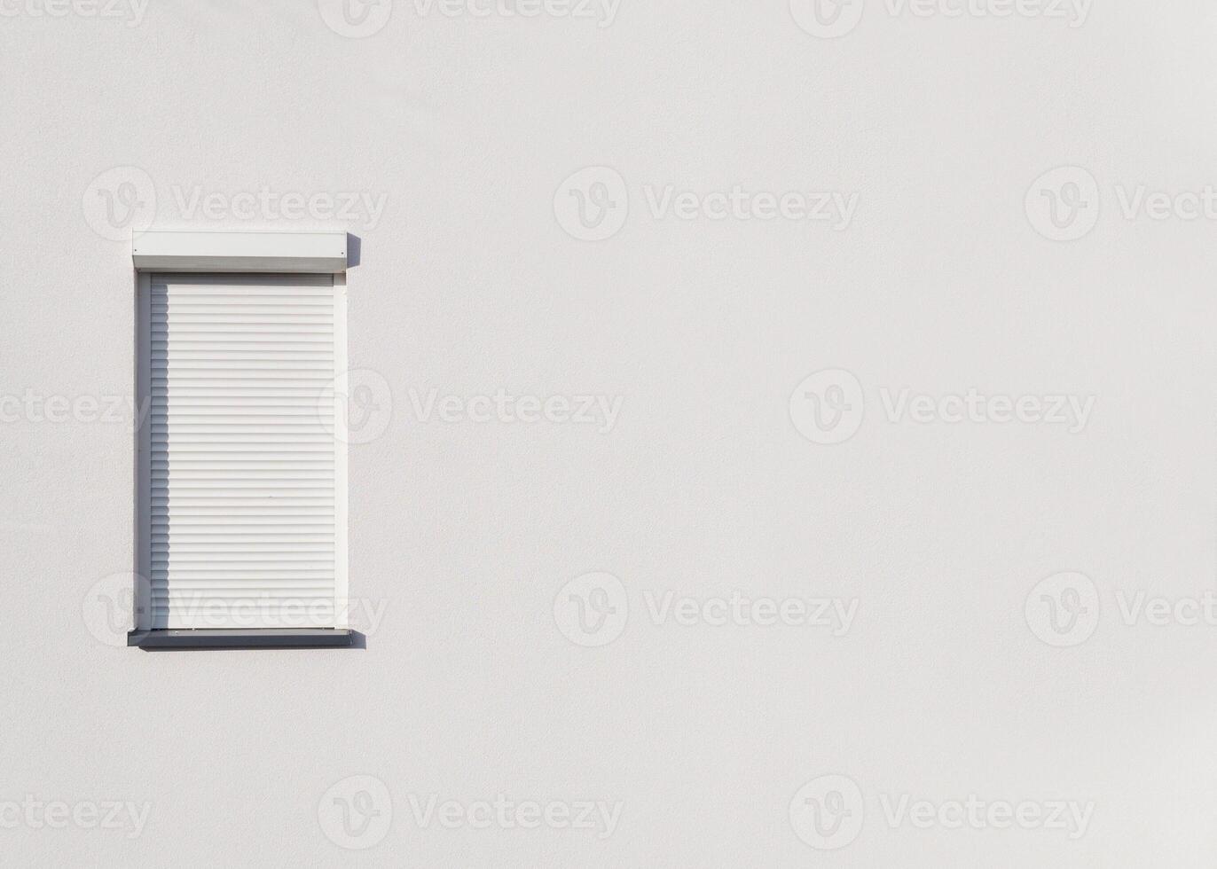 Tall Narrow Window Shutter on White Wall photo