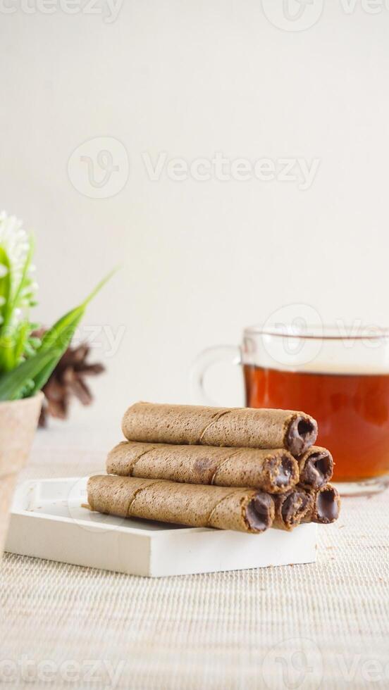chocolate wafer rolls and tea photo