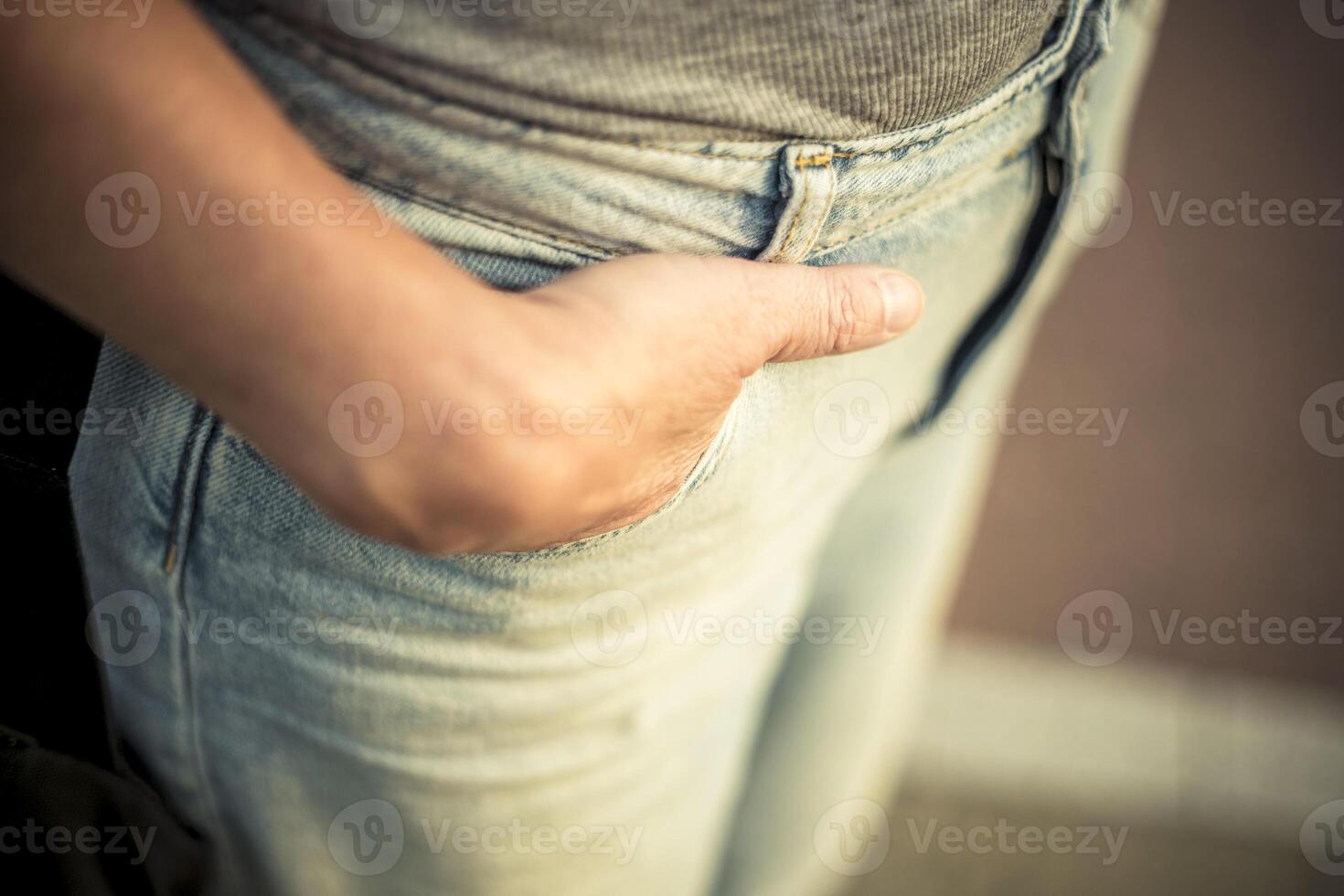 Casual closeup of hand in denim jeans pocket, textured blue fabric and relaxed body language photo
