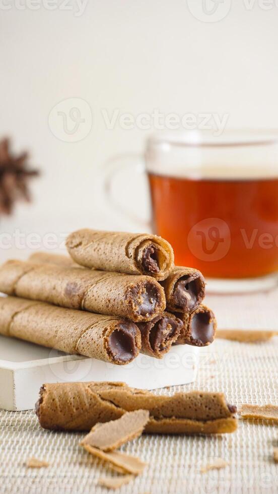 Chocolate rolled wafers with tea photo