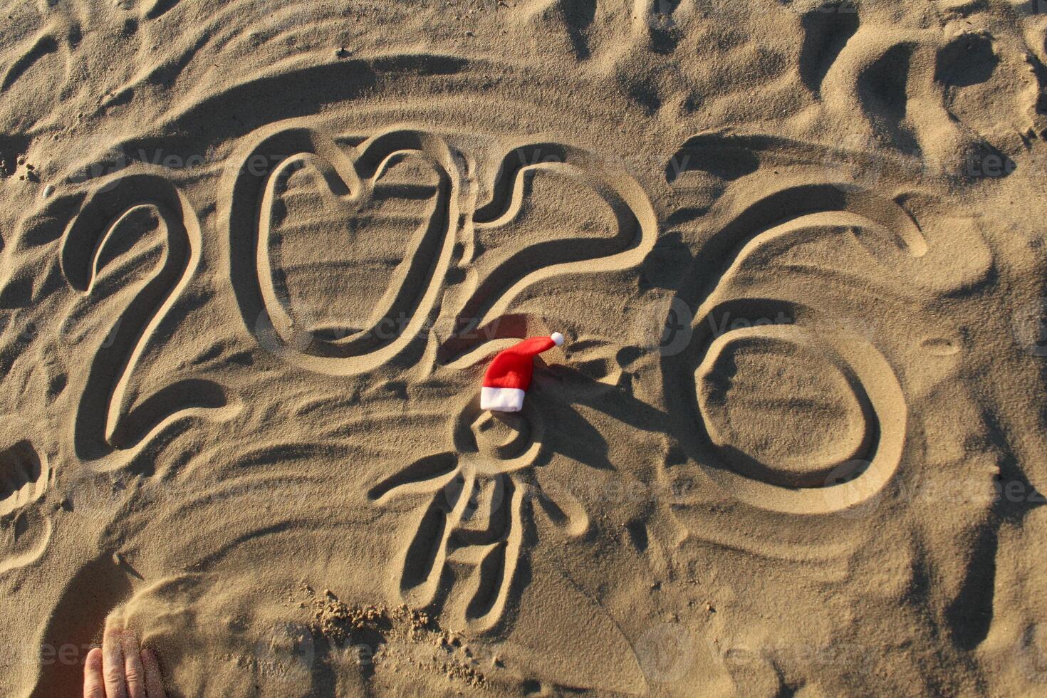 2026 and Santa Claus Hat on the Sand photo