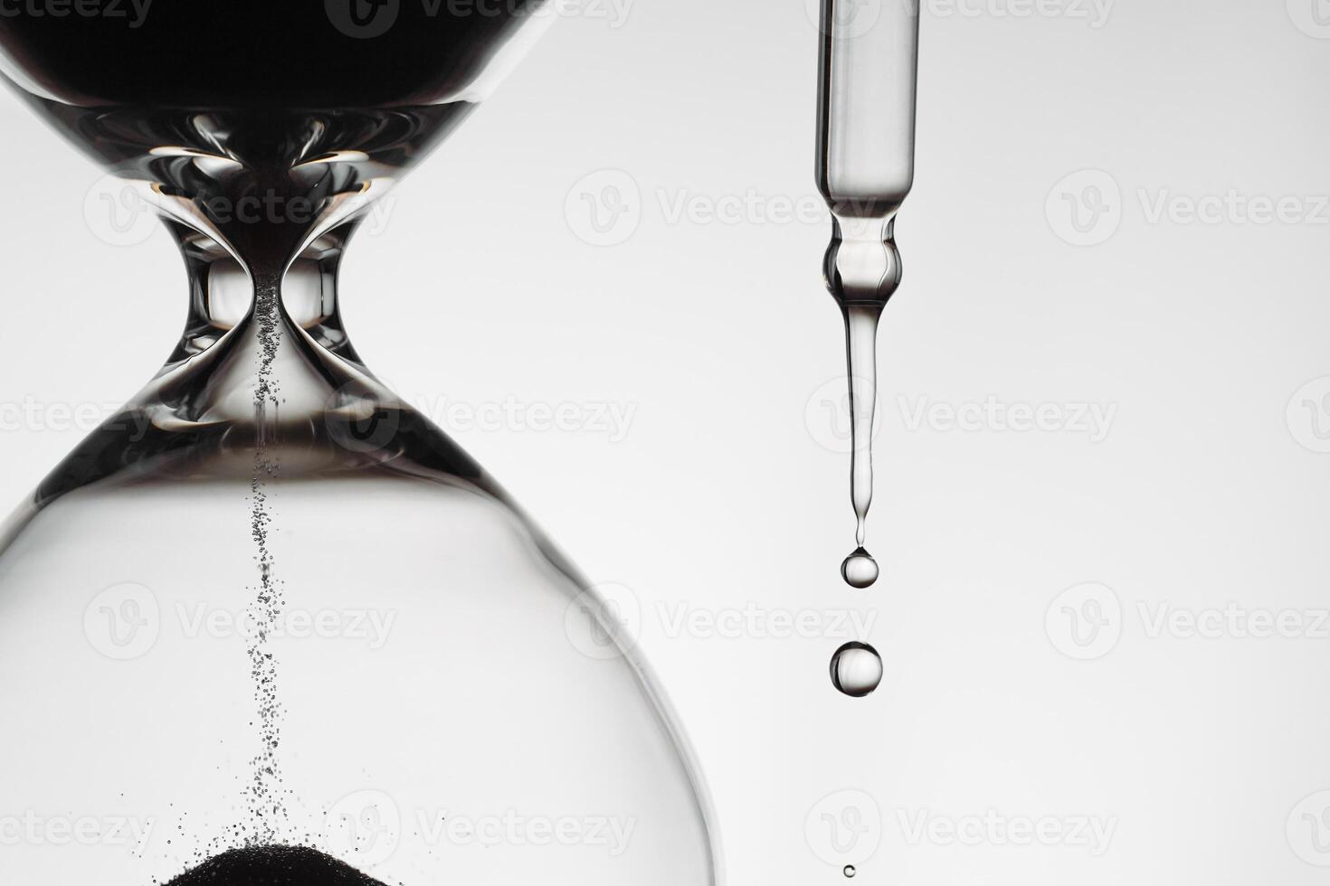 A minimalist conceptual image combining an hourglass and face serum droplets to symbolize the passage of time, aging, and importance of skincare, balance. photo