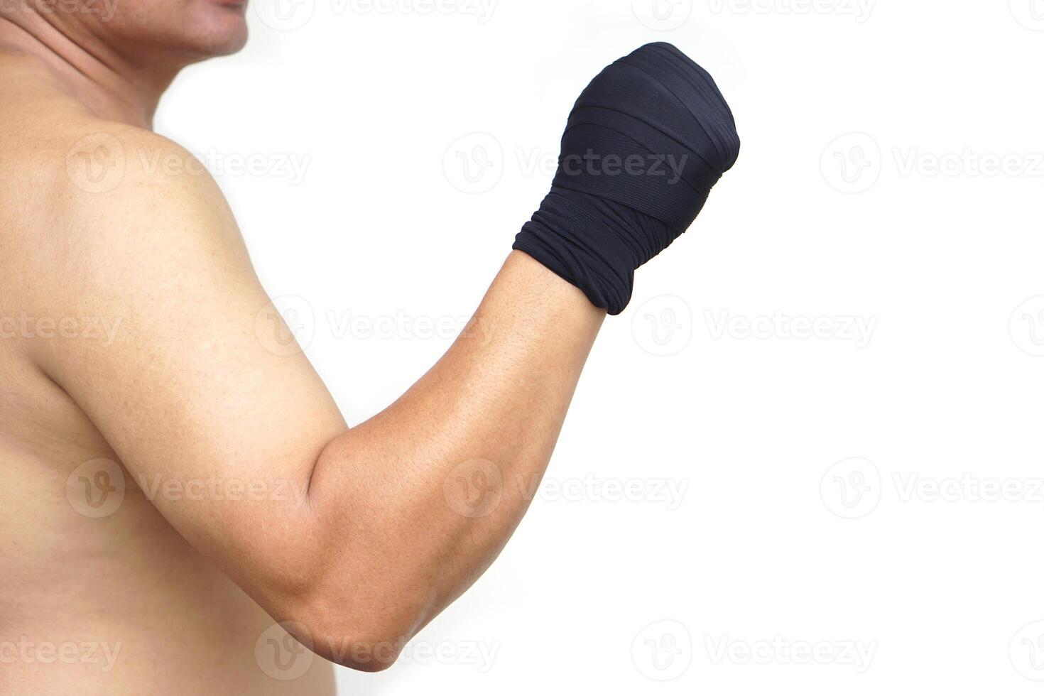 Close up Thai male boxer clenched fists wrapped in black hand wraps. Concept strength, discipline, and readiness. Perfect for promoting fitness, Muay Thai training, or martial arts self-defense. photo