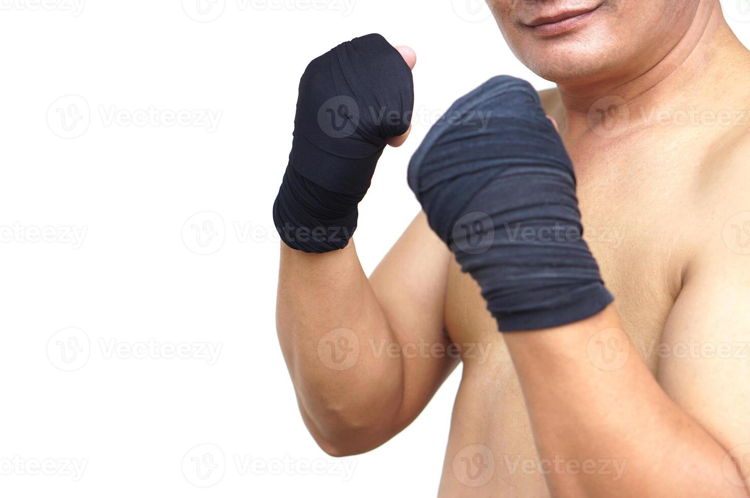 Crop shot of Thai male boxer clenched fists wrapped in black hand wraps. Concept strength, discipline, and readiness. Perfect for promoting fitness, Muay Thai training, or martial arts self defense. photo
