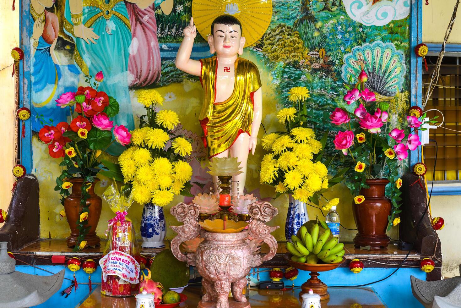 Vietnam - 21 May, 2024 Statue of Buddha with flowers and fruits in pagoda of vietnam photo