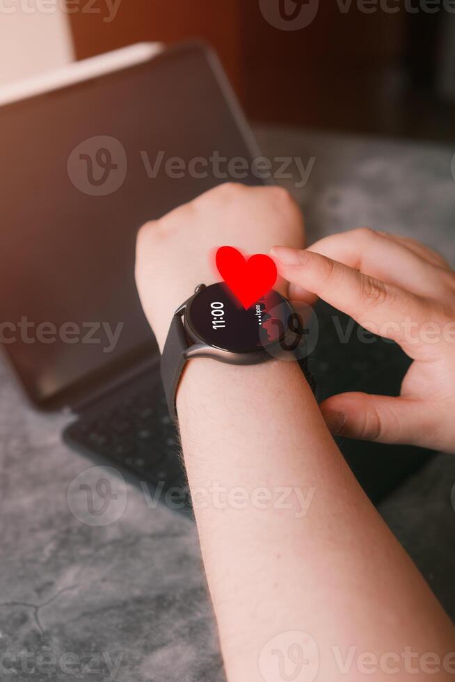 Close up of woman checking beat rate on smartwatch. Healthcare and technology concept. Application track health. photo