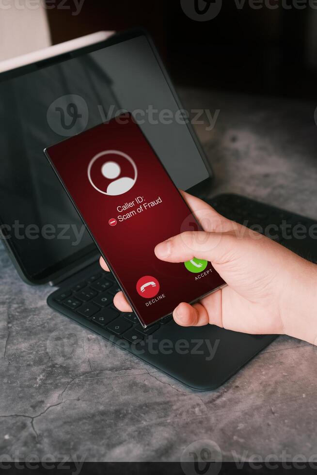 Woman receiving unwanted call on smartphone while working. Spam, scam, phishing and fraud concept. Security technology. photo
