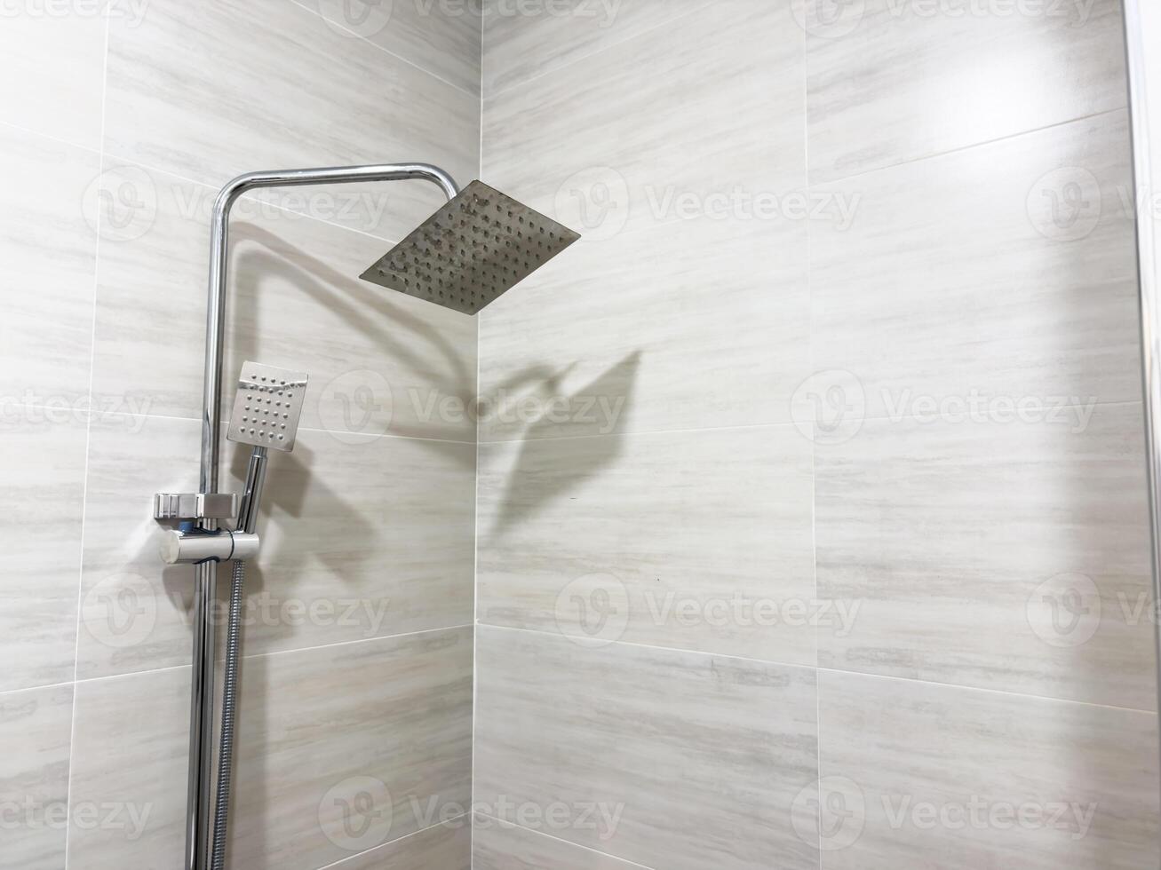 A shower head with a metal handle photo