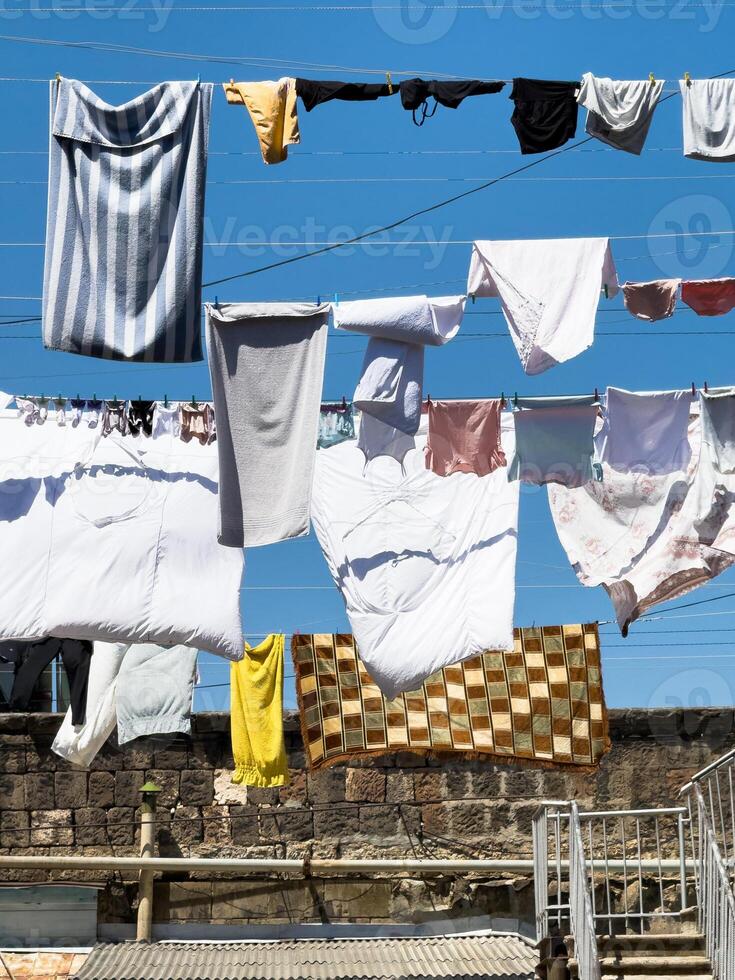 A line of clothes hanging on a clothesline photo