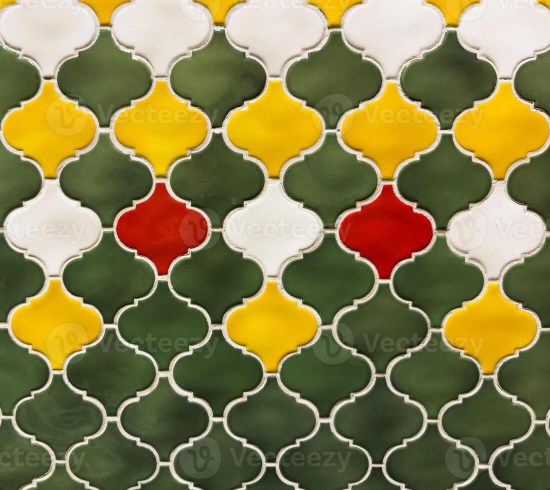 Wall background, A tile pattern with green, yellow, and white tiles photo