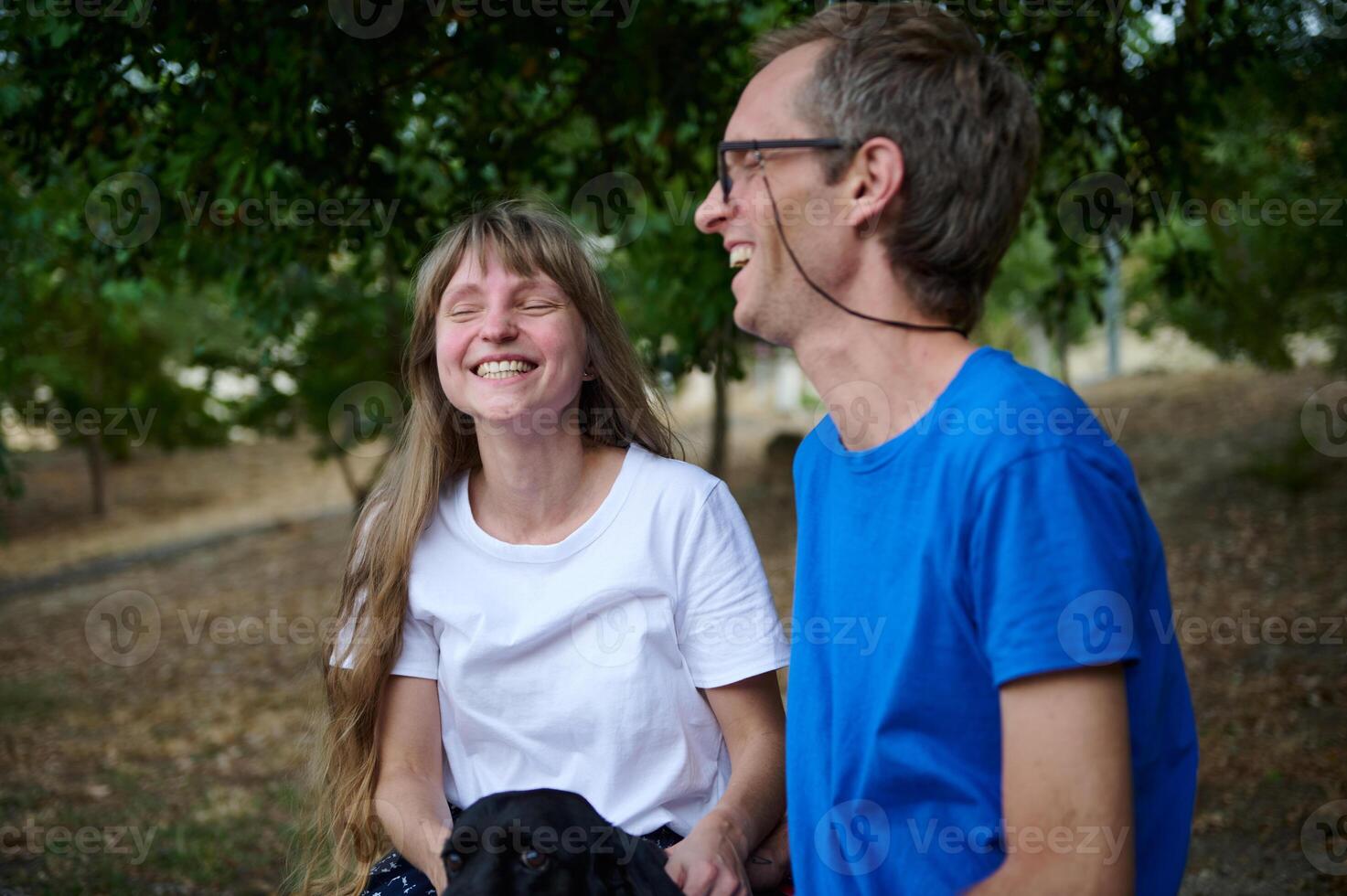 Joyful Outside Moment of Two Friends Laughing Together in Nature photo