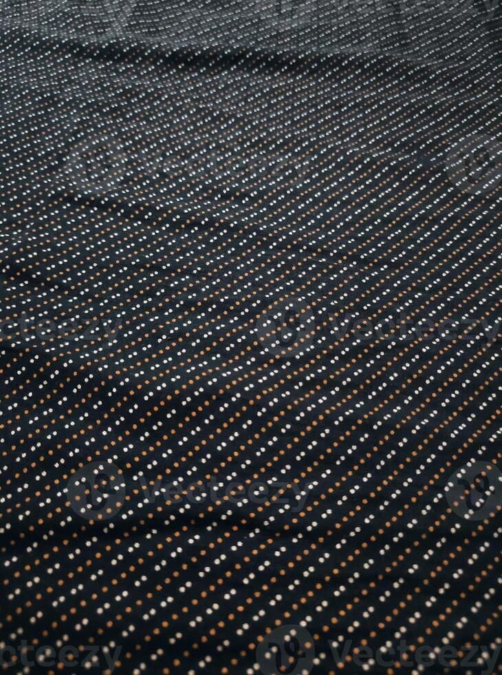 a black and white polka dot fabric with a white border photo