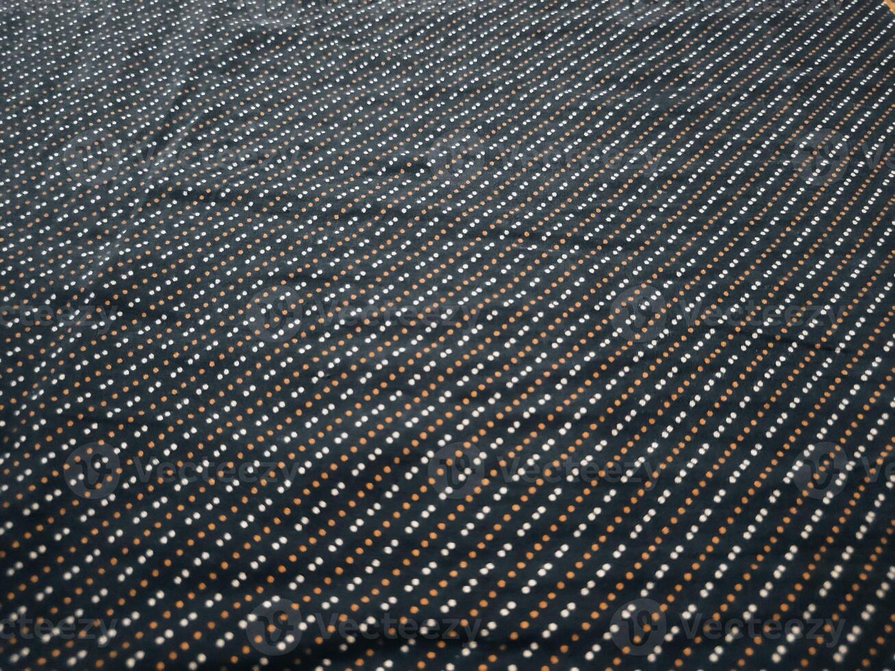 a black and white polka dot fabric with white border photo