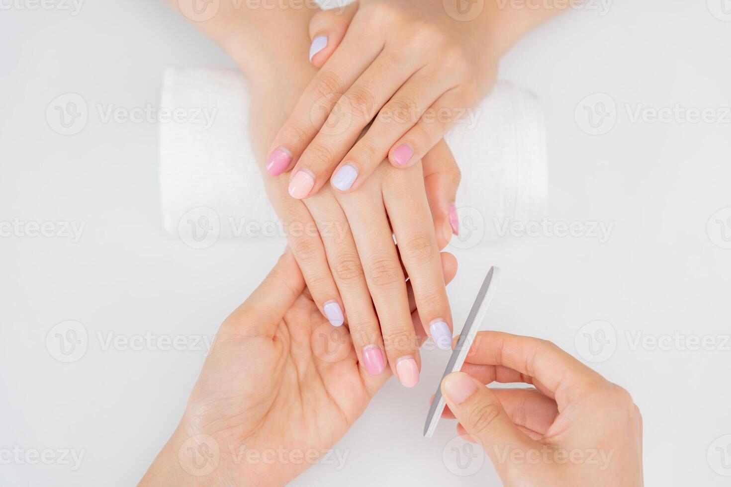 receive care service by professional Beautician Manicure at spa centre. Nail beauty salon use nail file for Glazing treatment. manicurist make nail customer to beautiful, body care spa treatment photo