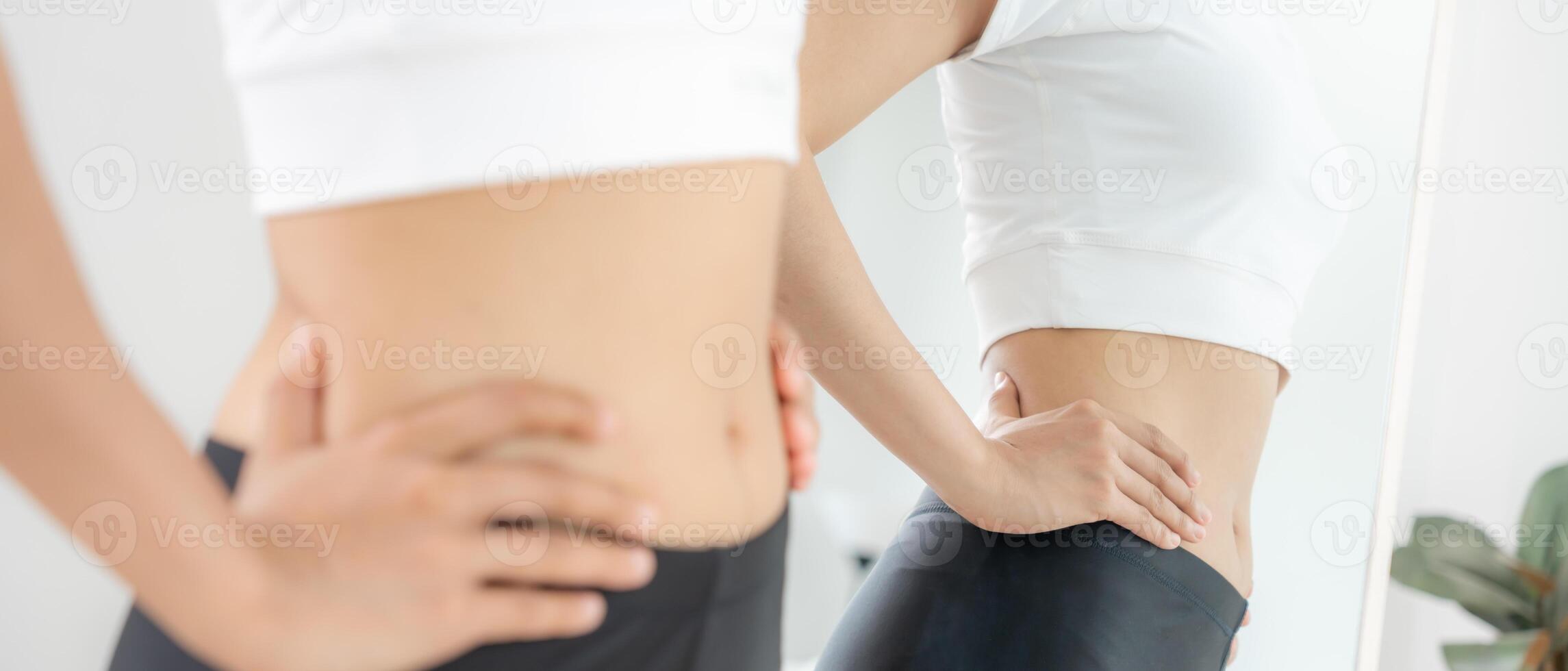 Women showing results of diet. Beautiful shape. female look mirror for check shape body have a reduced waist size after under going a weight loss corse. balance, control, routines, exercis. photo
