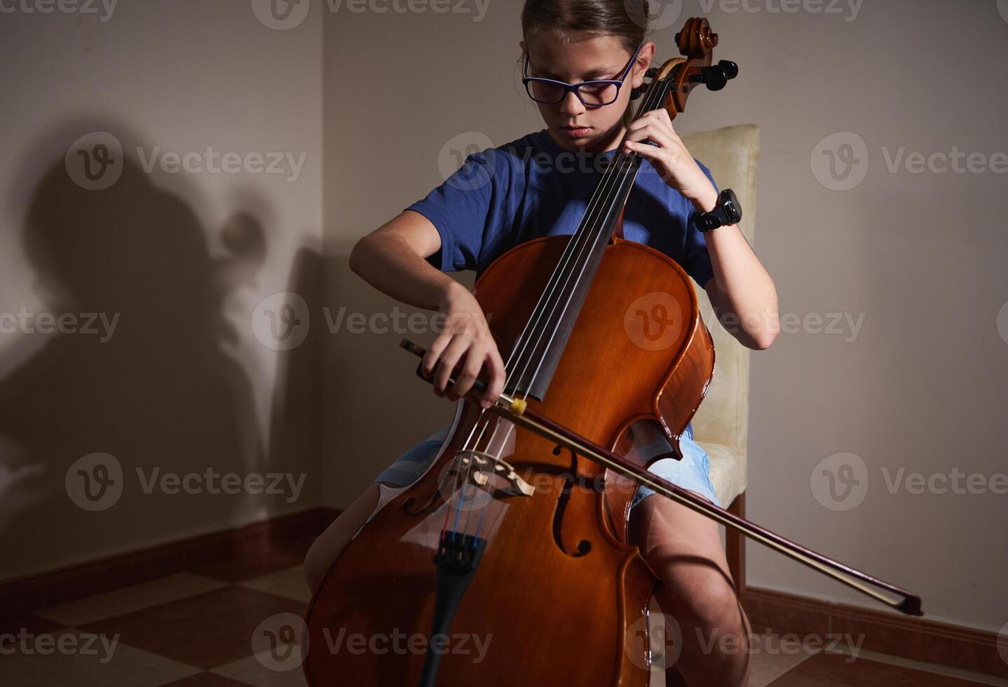Young Musician Practicing the Cello in a Peaceful Indoor Setting photo