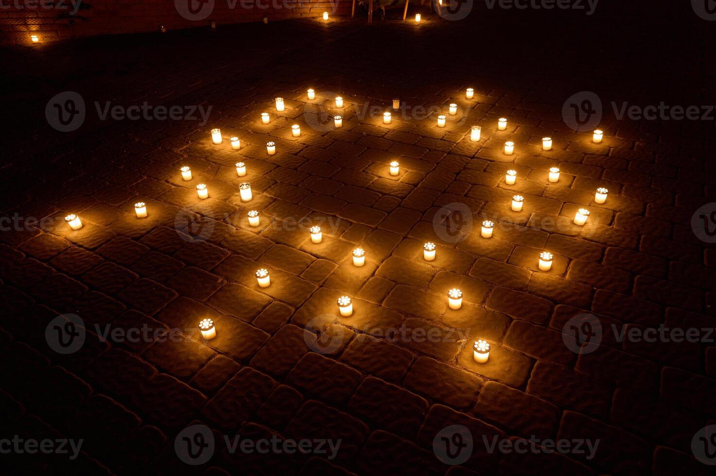 Evening Candle Arrangement Sparkles on Cobblestone Patio Illuminating Serenity photo