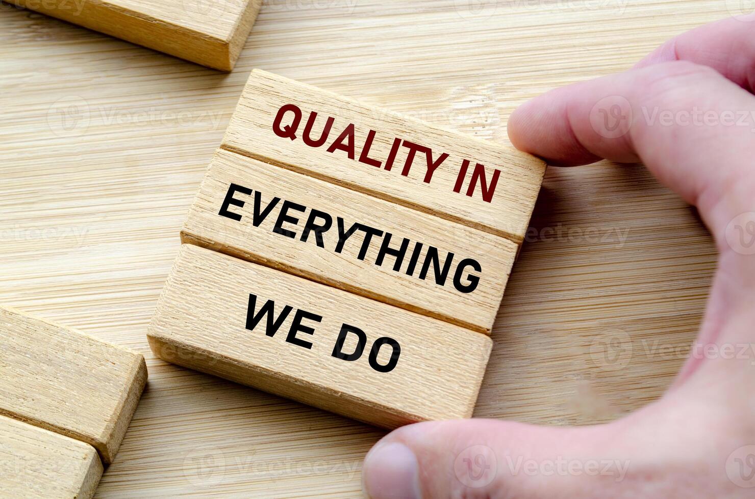 Quality in everything message held with both hands symbolizes attention to detail and pride in craftsmanship photo
