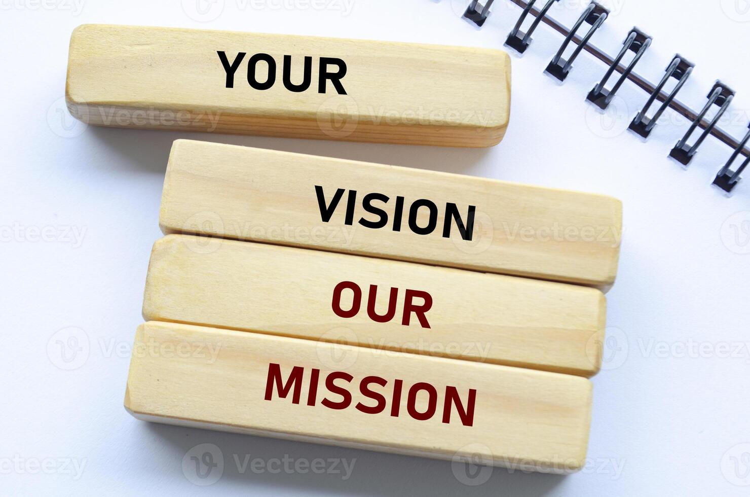 Your vision our mission text on wooden blocks and notebook emphasizes alignment with client goals and shared purpose photo