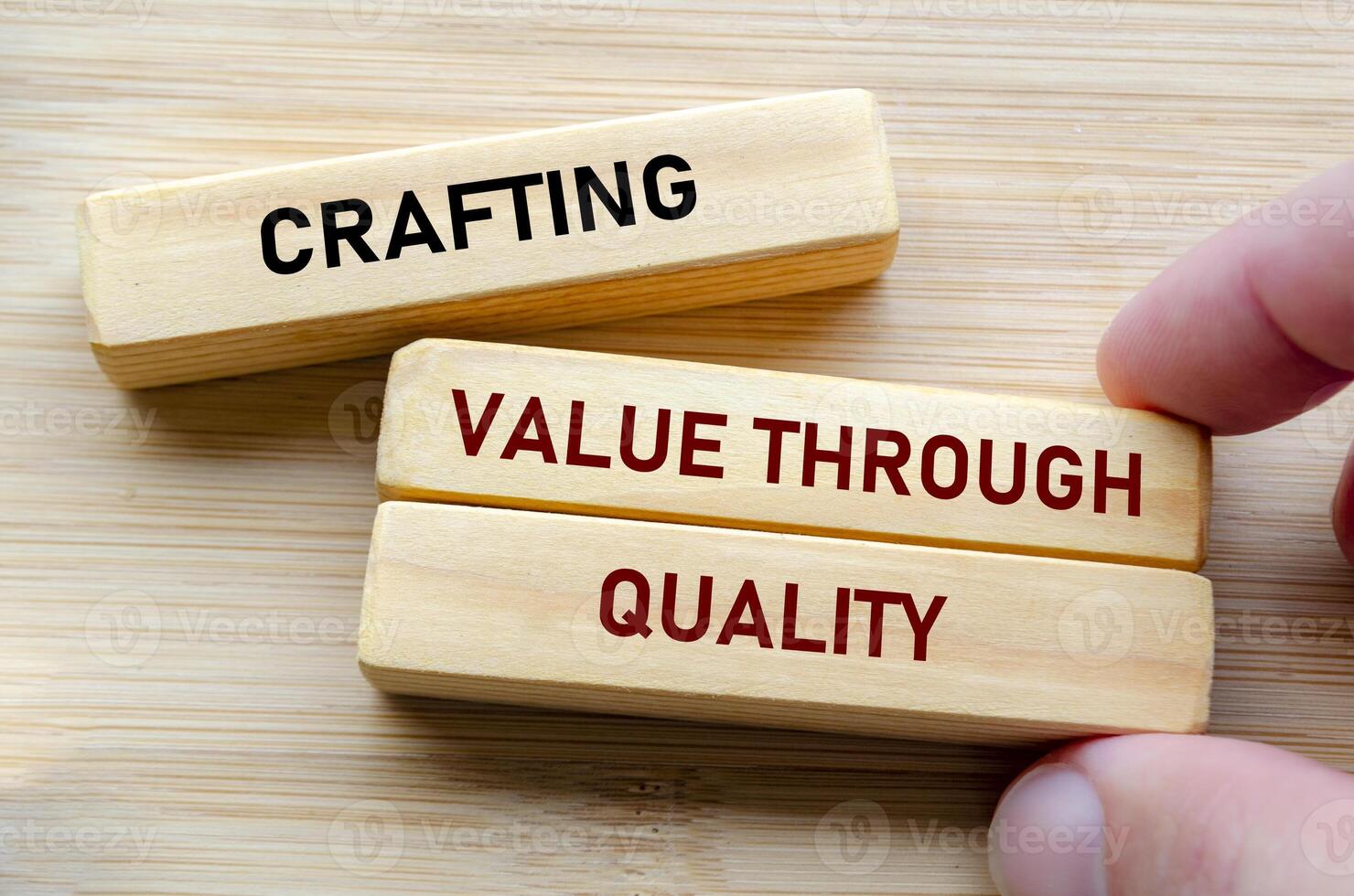 Crafting value through quality text on wooden blocks represents the foundation of excellence and dedication in every detail photo